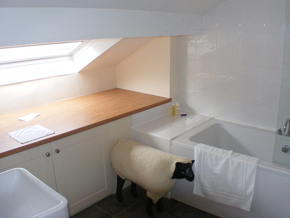 Grand placard le long de la fenêtre avec une baignoire et un lavabo à la perpendiculaire