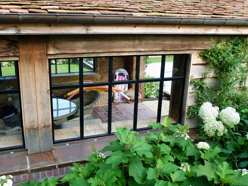 Verrière à grands carreaux sous un toit de tuiles